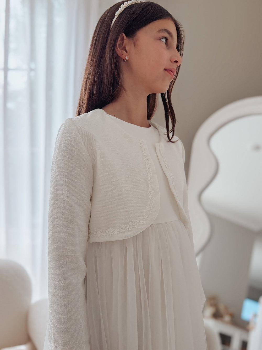 girls white jacket layered over formal dress