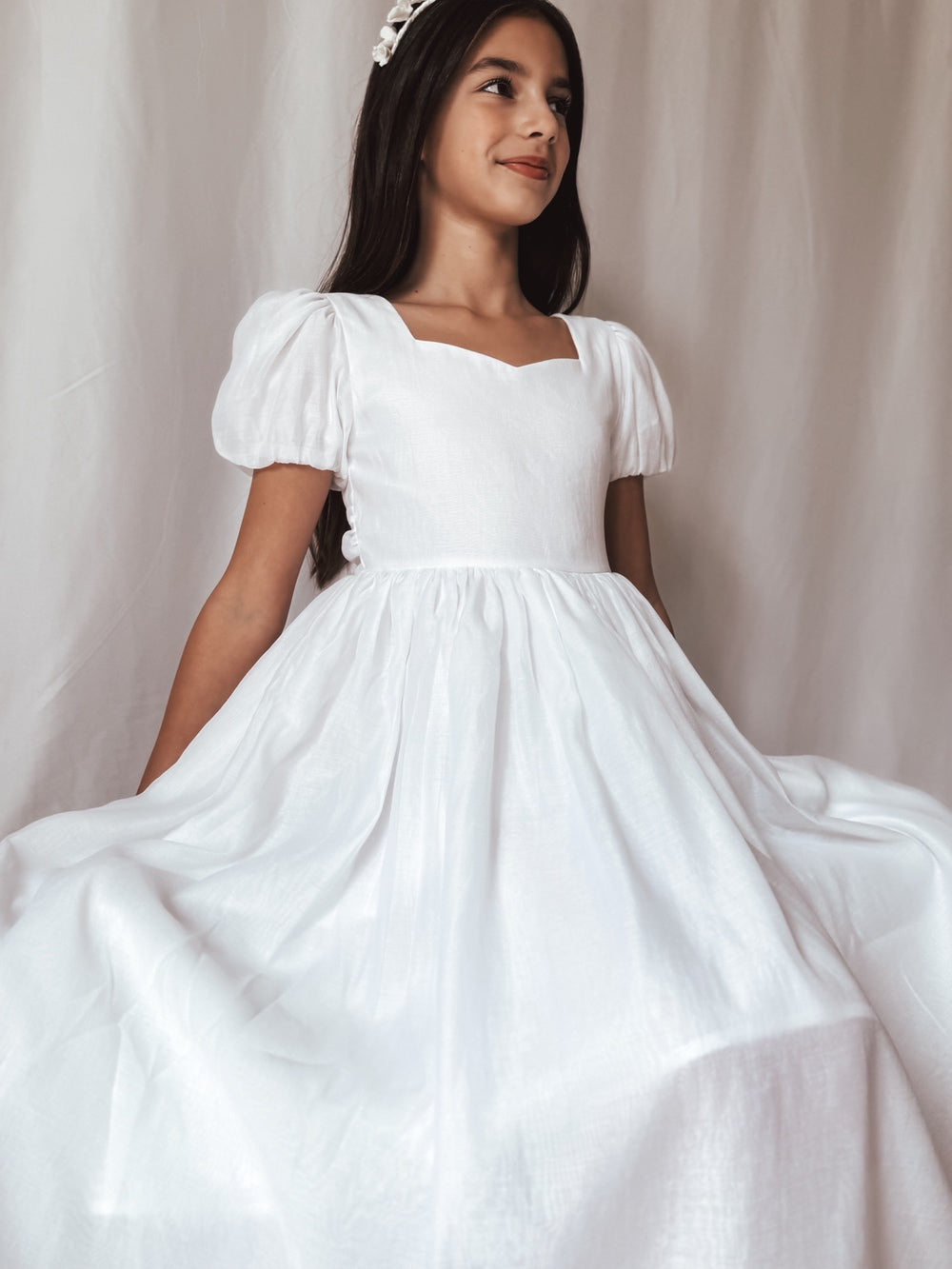 Girls white Communion dress with puff sleeves and large bow
