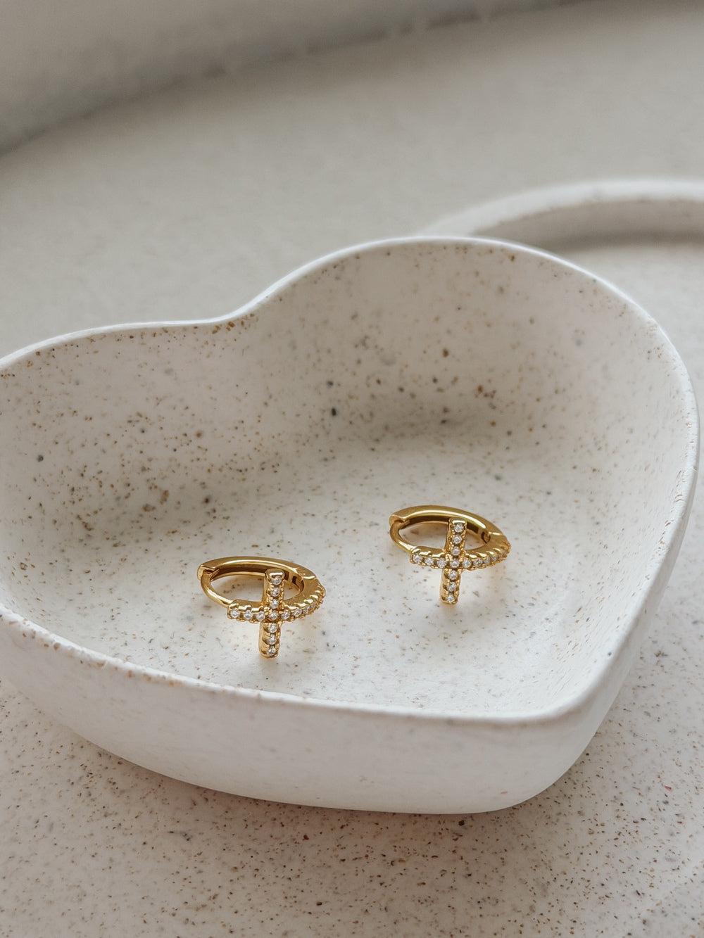 Pair of Girls Gold Cross Earrings displayed in jewellery dish – perfect Communion gift