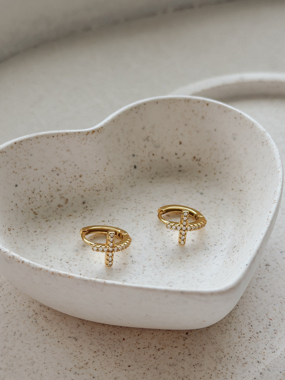 Pair of Girls Gold Cross Earrings displayed in jewellery dish – perfect Communion gift