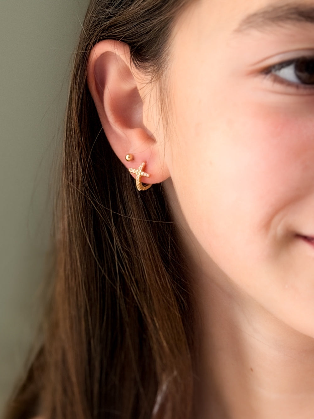 Close-up of Girls Gold Cross Earrings showing delicate diamante cross charm and polished gold hoops