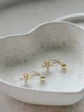 Pair of Girls Gold Flower Earrings displayed in a jewellery dish– perfect for Communion or special occasions