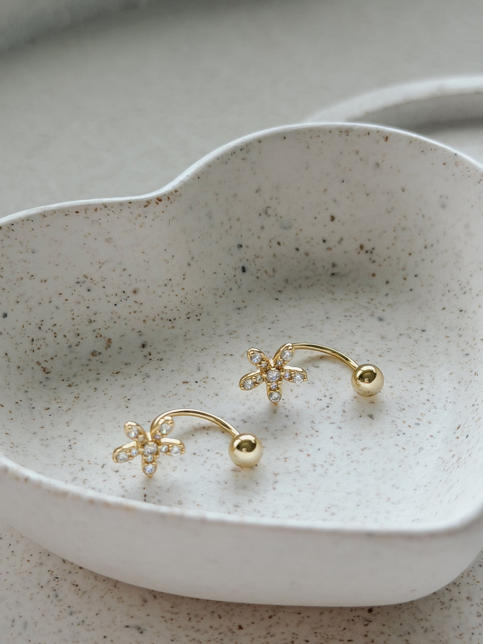 Pair of Girls Gold Flower Earrings displayed in a jewellery dish– perfect for Communion or special occasions