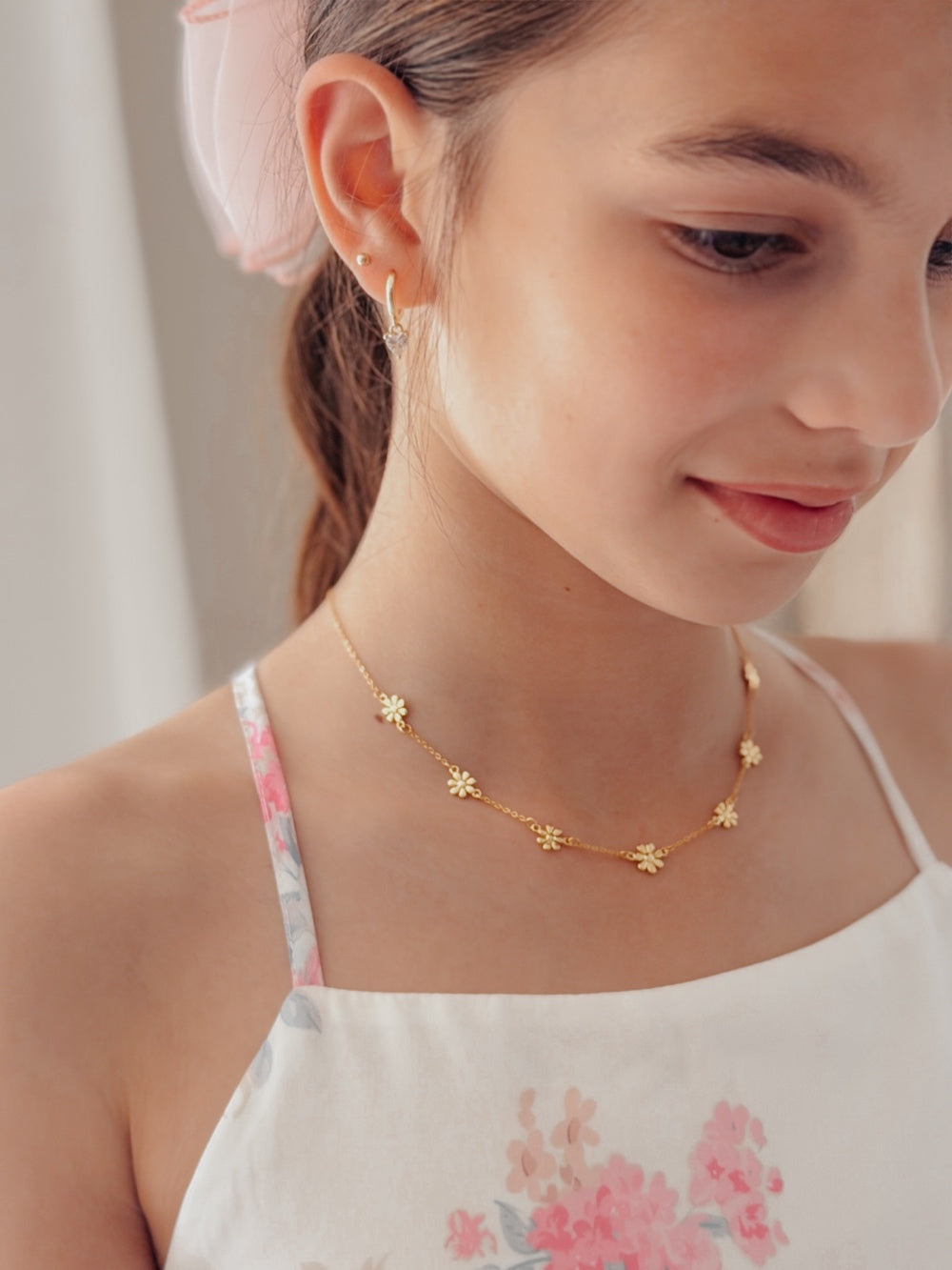 Close-up of gold daisy necklace for girls featuring delicate flower details