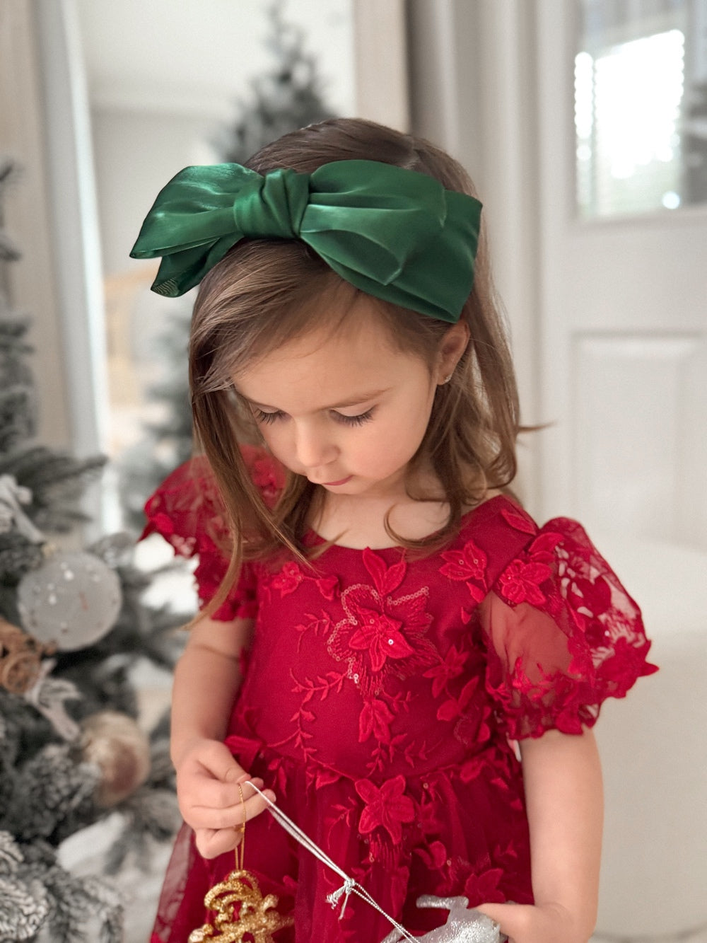 Green Bow Girls Headband - Christmas AccessoriesGreen bow girls Christmas headband styled in hair