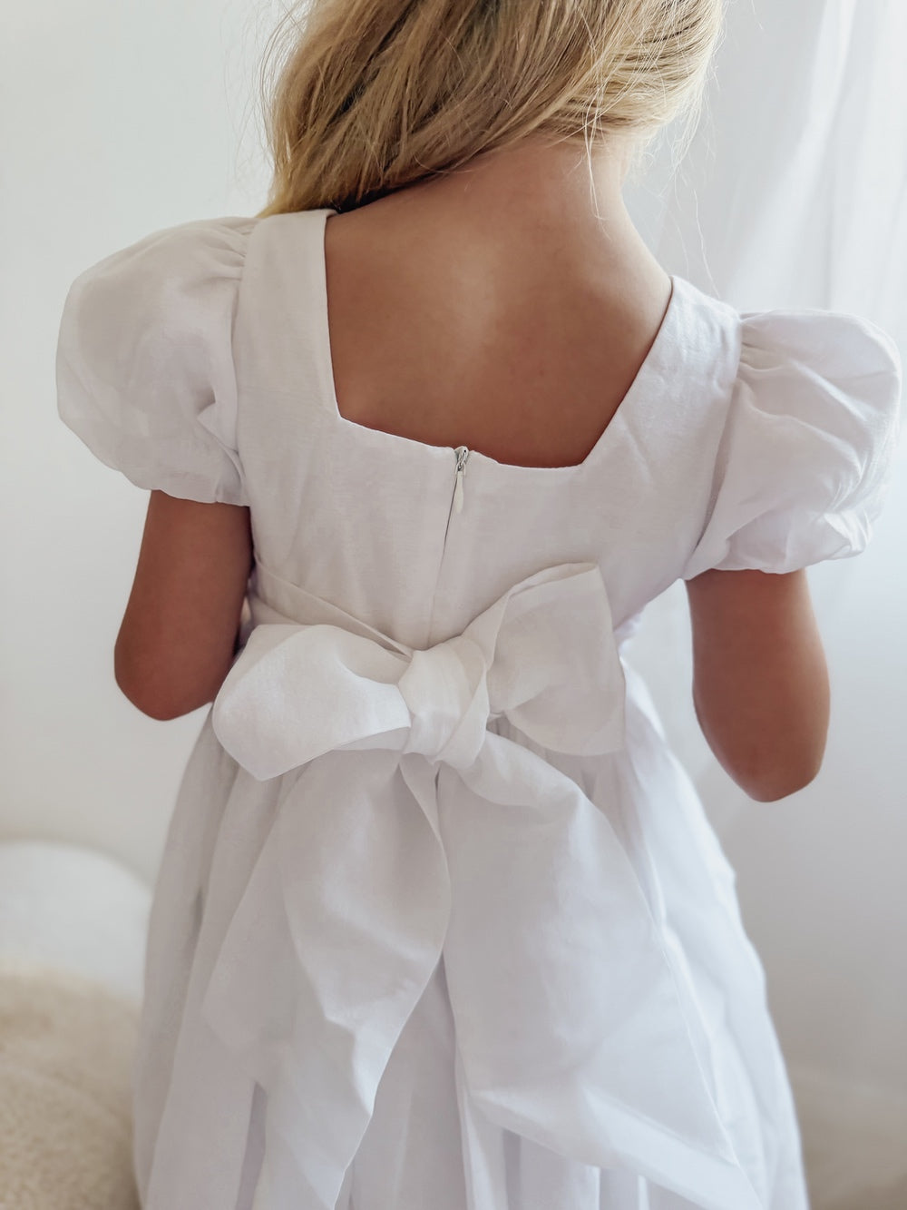 Girls holy communion dress in white with large bow and square back