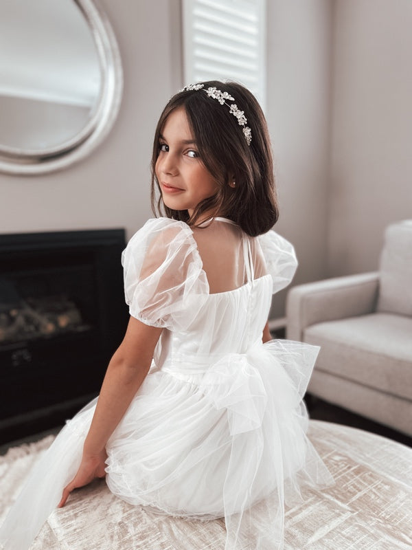 Modern white communion dress with puff sleeves
