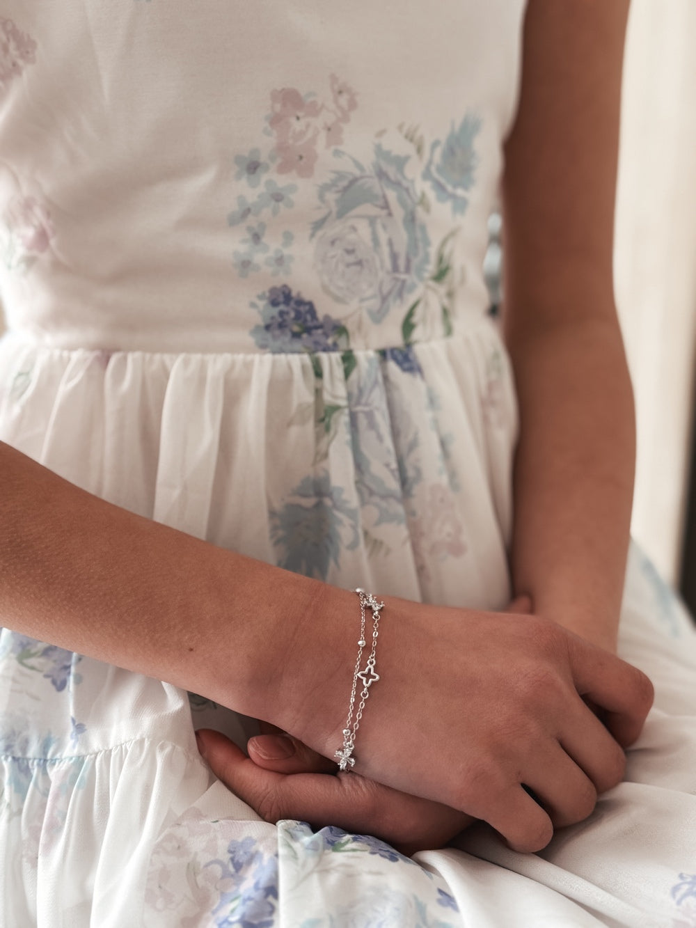 Close-up of silver beads and diamante cross charms on Harmony bracelet