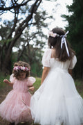 Girls white and pink flower girl dresses with matching flower crowns.