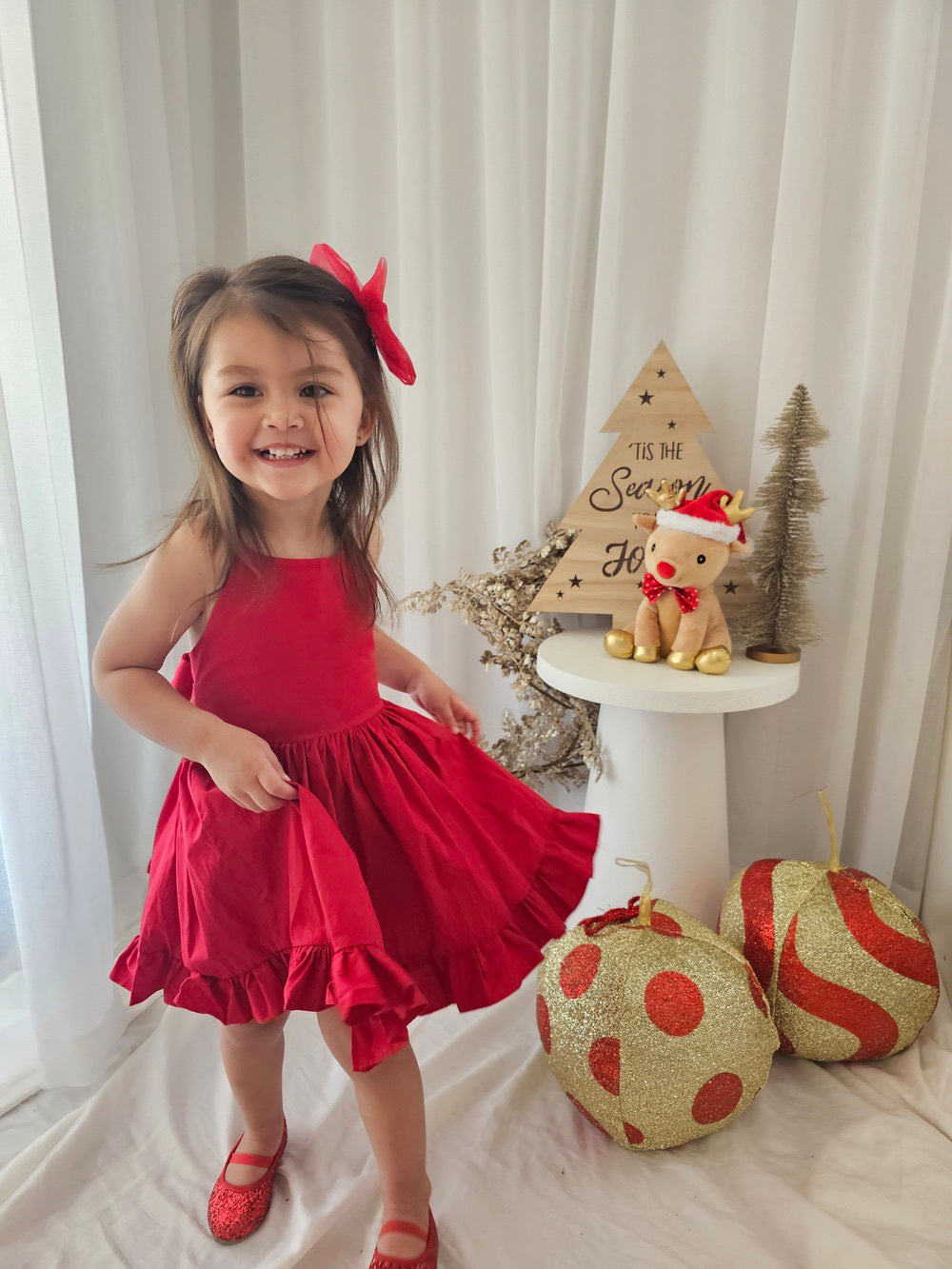 Holly Girls Christmas Dress styled with red bow for festive photos