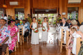 Two flower girls throwing flowers down the isle in matching Isabelle Dresses with lace-up backs and soft chiffon skirts