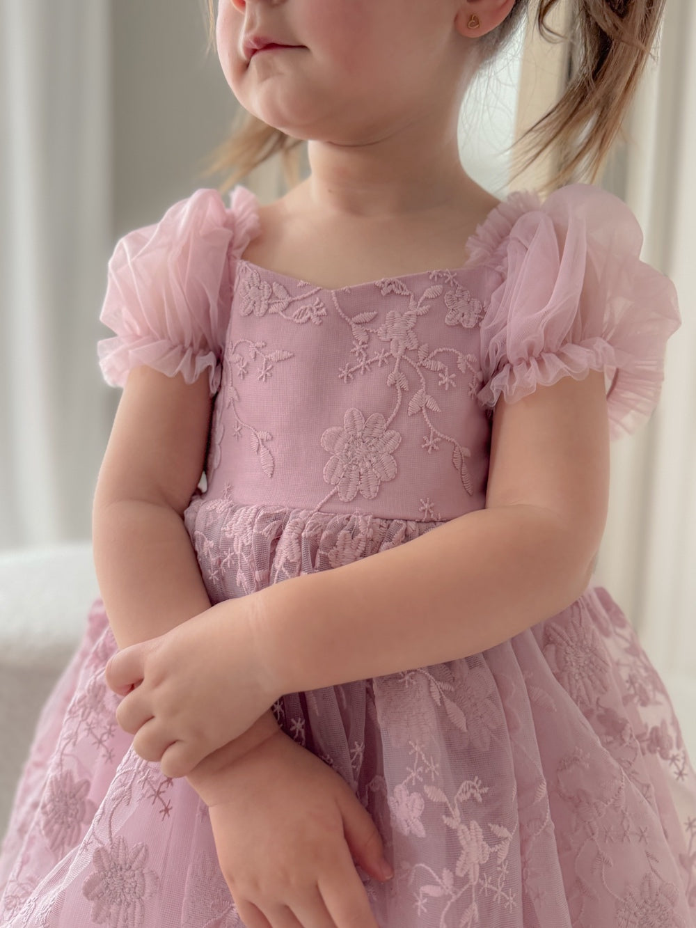 Rear angle of dress highlighting the puff sleeve detail and lace design