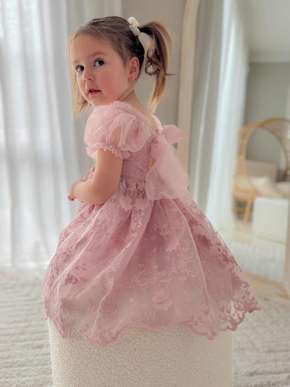 Rear angle of dress highlighting the bow-back detail and lace design