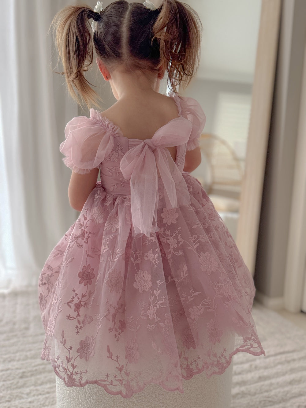 Rear angle of dress highlighting the bow-back detail and lace design