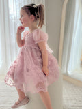 Side profile of girl in dusty pink dress showing flow and silhouette