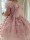 Back view showing tulle tie-up of dusty pink dress