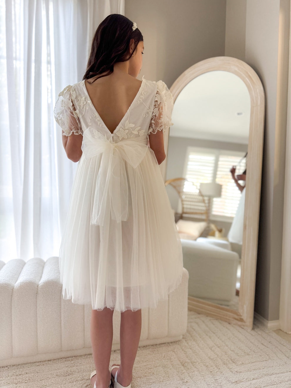 Full-length photo of Laura ivory dress styled for formal occasion