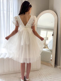 Laura ivory dress styled for a wedding with elegant bow tie at the back