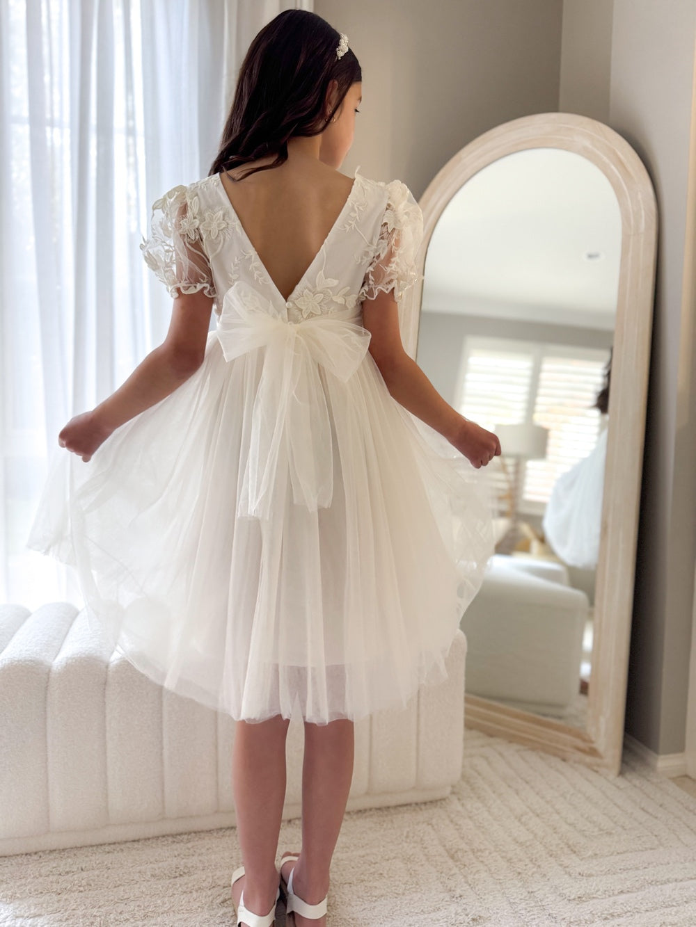 Laura Puff Sleeve Ivory Flower Girl Dress - Flower Girl DressesLaura ivory dress styled for a wedding with elegant bow tie at the back