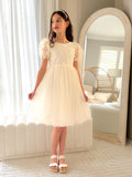 Front view of Laura ivory flower girl dress with floral embroidery and puff sleeves