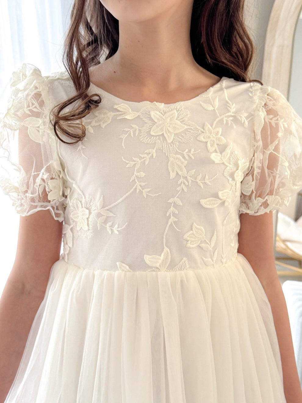 Close-up of cotton lining and fabric texture on ivory flower girl dress