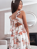 Back view of Leilani girls red and pink rose print dress with tie-up detail