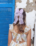 Girl’s lilac organza curly bow clipped into hair