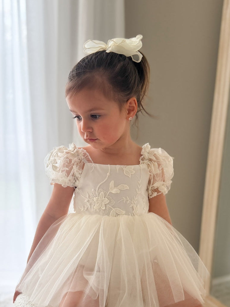 Lifestyle photo – baby wearing Lila Ivory Embroidered Baby Dress for baptism or wedding