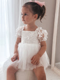 Baby sitting in Lila White Embroidered Baby Dress – elegant outfit for christenings
