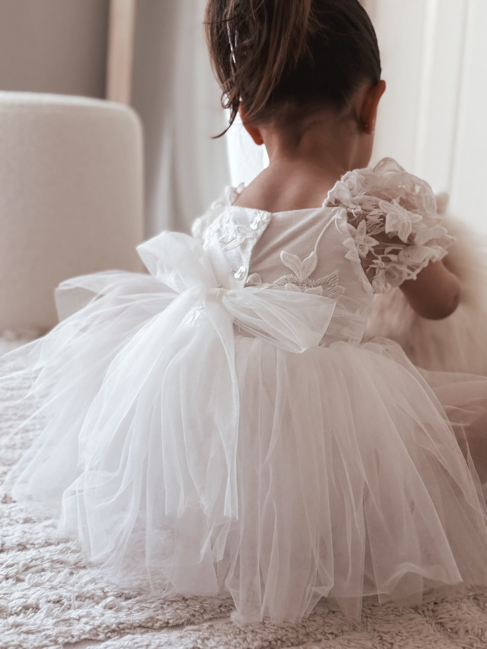 Side view of Lila White Embroidered Baby Dress – puff sleeves and layered tulle skirt