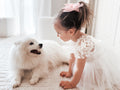 Lifestyle photo – baby wearing Lila White Embroidered Baby Dress for baptism or wedding