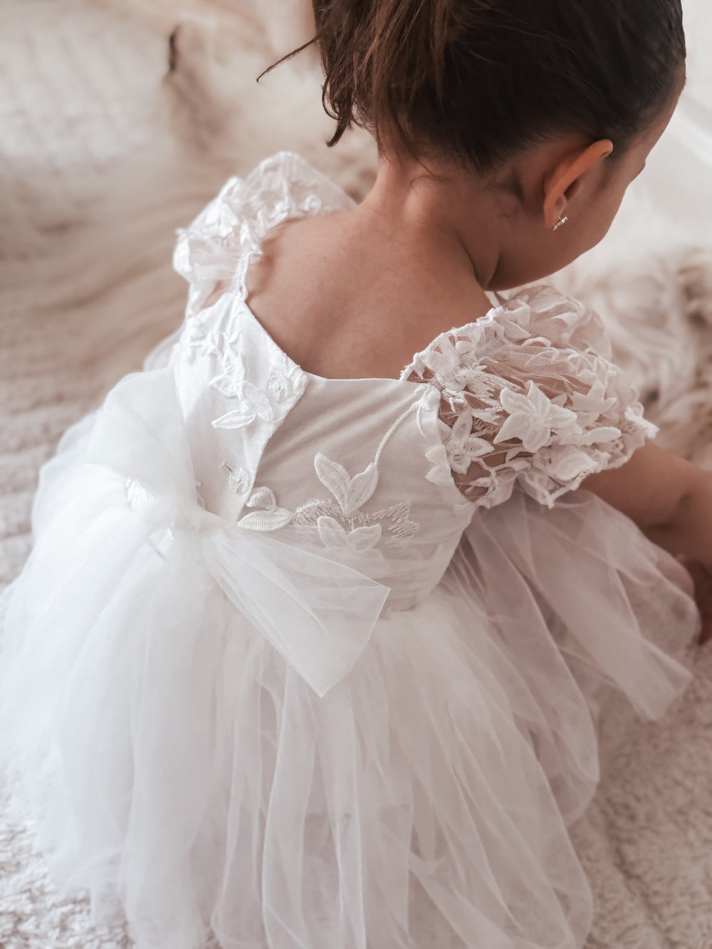 Close-up of embroidered bodice and puff sleeve design – Lila White Baby Dress