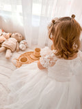 girls christening dress in white with elegant puff sleeves