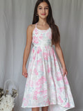 Close-up of pink floral pattern on the Lola girls graduation dress.