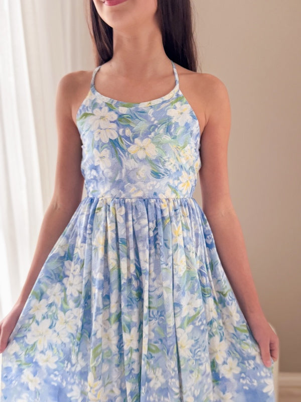 Tween girl smiling in light blue floral dress, ideal for Year 6 graduation photos