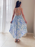 Girl in floral high-low dress standing, soft fabric in motion