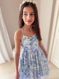 Light blue girls graduation dress with white and green floral print and high-low hem