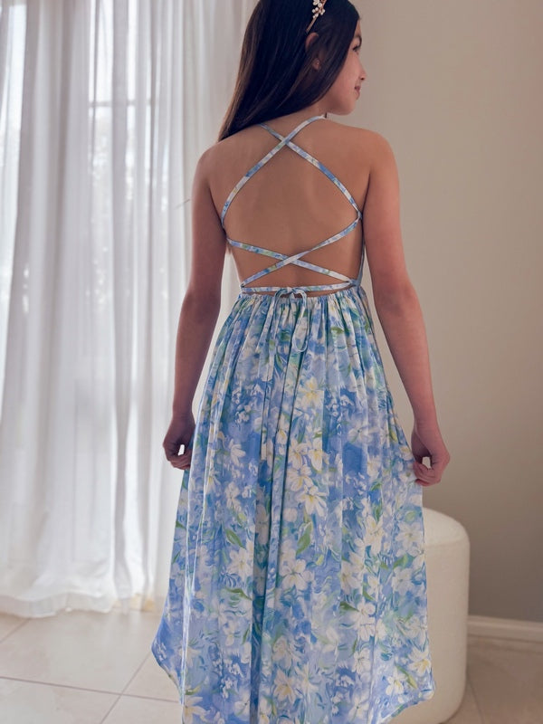 Girl in floral high-low dress walking, soft fabric in motion