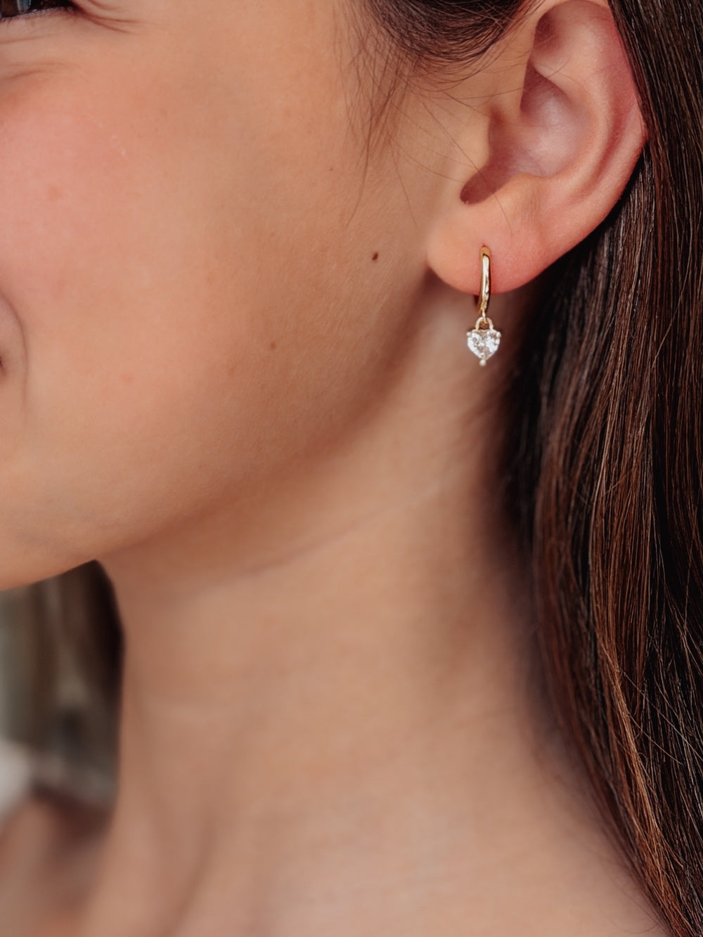 Close-up of Love Heart Girls Gold Hoop Earrings showing tiny heart charm