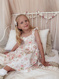 Girl in Lucinda Floral Dress with matching pigtail bows for coordinated look