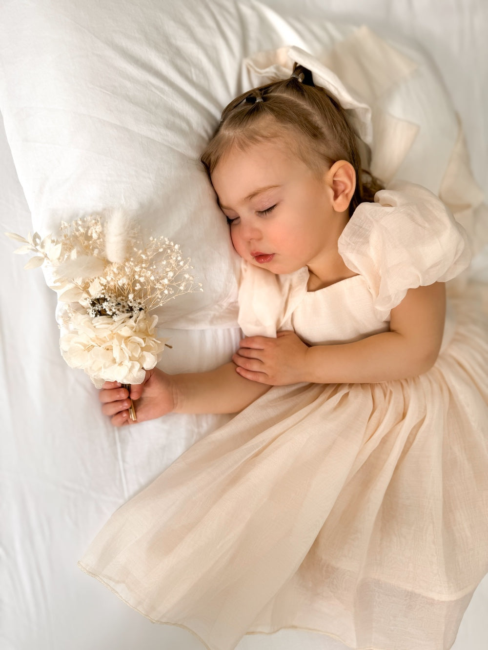 Front view of champagne baby dress with puff sleeves and tulle skirt