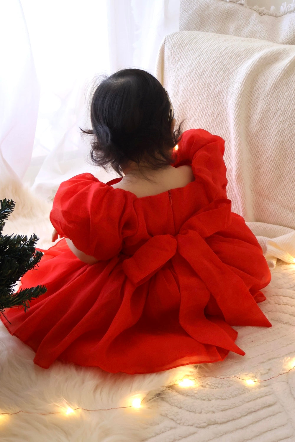 Lucy Baby Girls Red Christmas RomperClose-up of red baby Christmas dress with large bow and puffed sleeves
