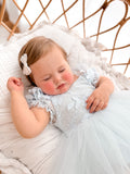 Lila dusty blue embroidered baby dress, bodice close-up.