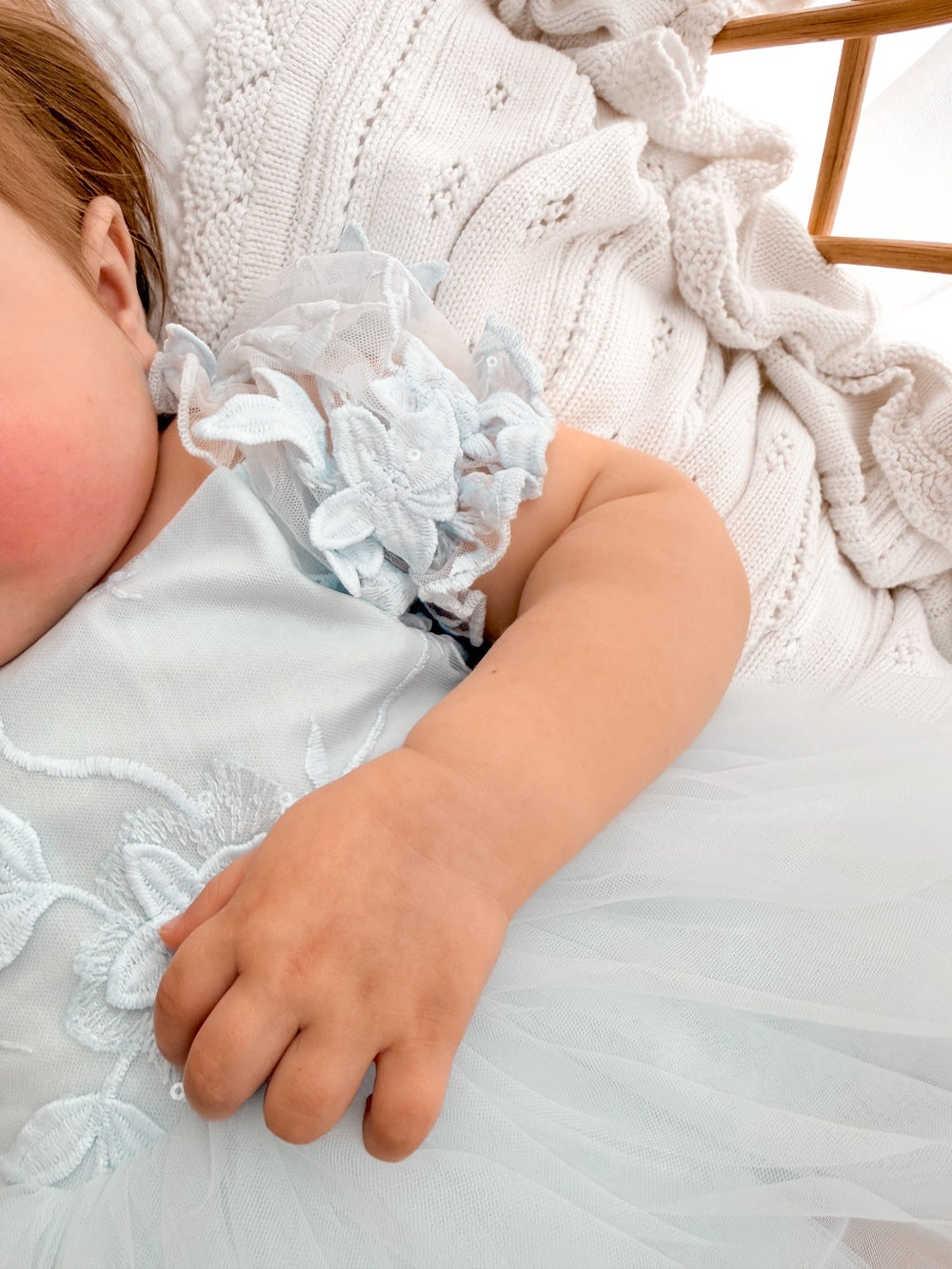 Lila dusty blue embroidered baby dress, floral puff sleeve close-up.