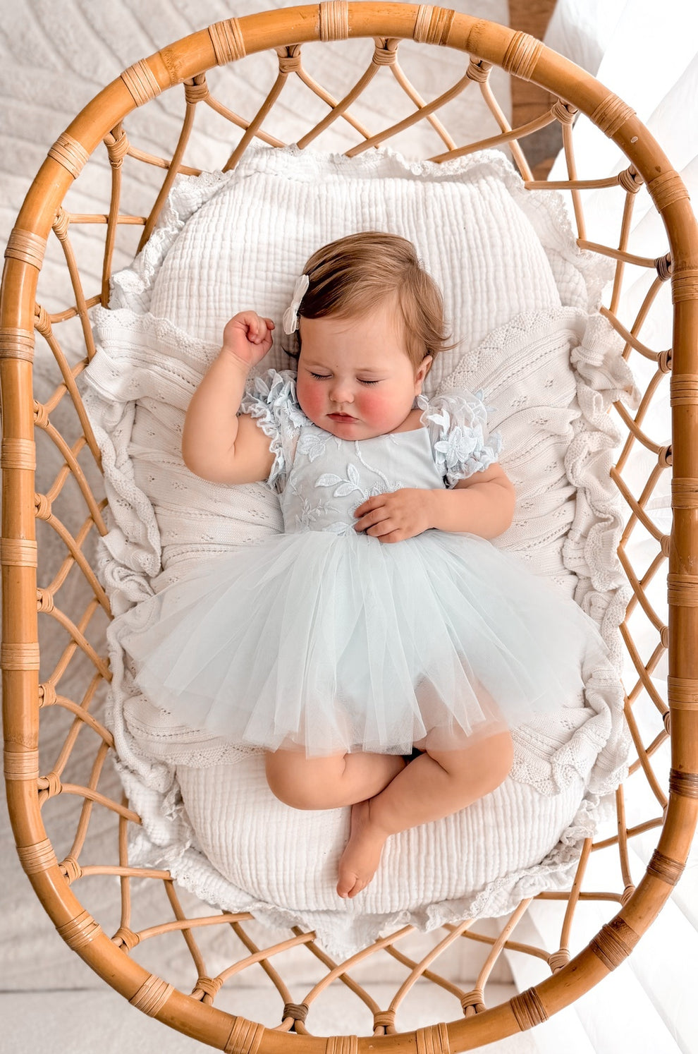 Lila dusty blue embroidered baby dress, overhead view.