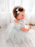 Lila dusty blue baby dress, three-quarter back view.