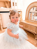 Lila dusty blue embroidered baby occasion dress, side view.