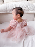 Lila soft pink baby dress, back view with tulle bow.