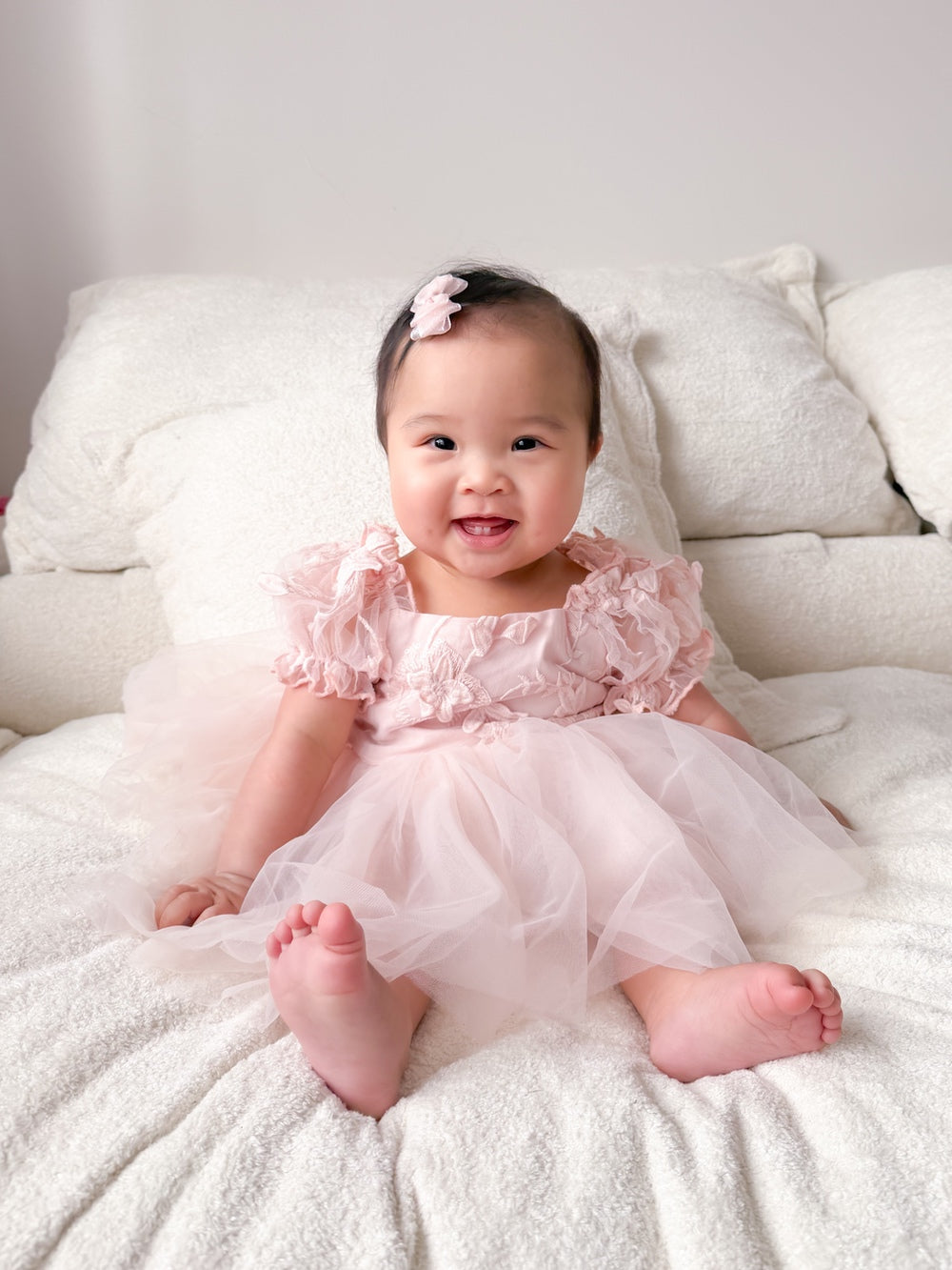 Lila soft pink baby first birthday dress with embroidered bodice and tulle skirt.