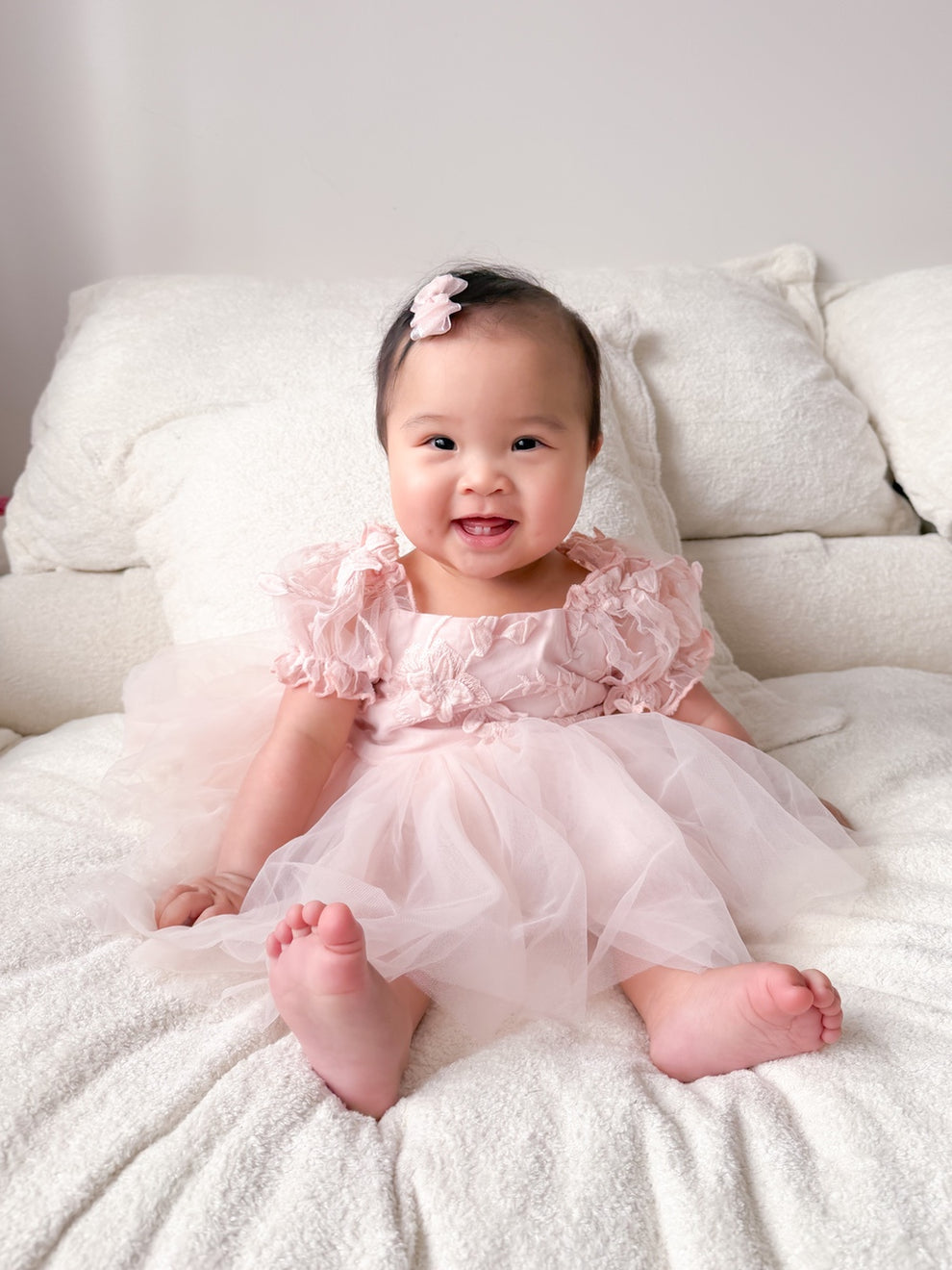 Lila soft pink baby first birthday dress with embroidered bodice and tulle skirt.